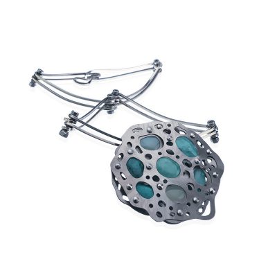 image of a necklace with a brooch pendant of tension set stones and a segmented necklace shaped in a D and a diamond