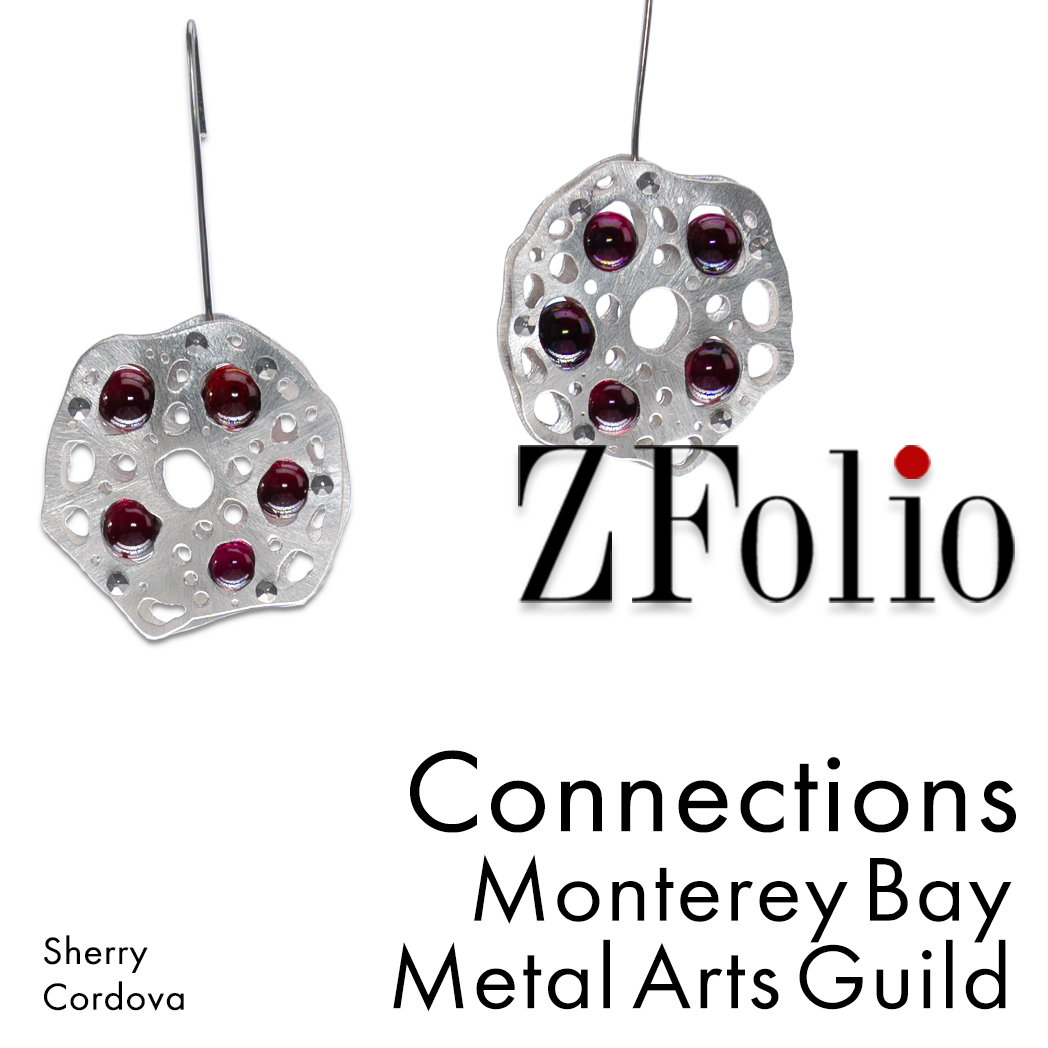 10 large garnet spheres tension set in a pair of sterling silver (low tarnish) earrings with niobium earwires. for the Connections exhibit at ZFolio gallery in Monterey California. Earrings by Sherry Cordova. Exhibit + sale sponsored by the Monterey Bay Metal Arts Guild