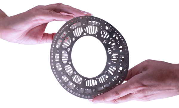 CITDSM oval cuff Bracelet by Sherry Cordova is made in low tarnish sterling silver and pure titanium held between 2 hands. The bracelet is made with 3 layers of sheet metal laser cut to highlight voids and spaces in between.